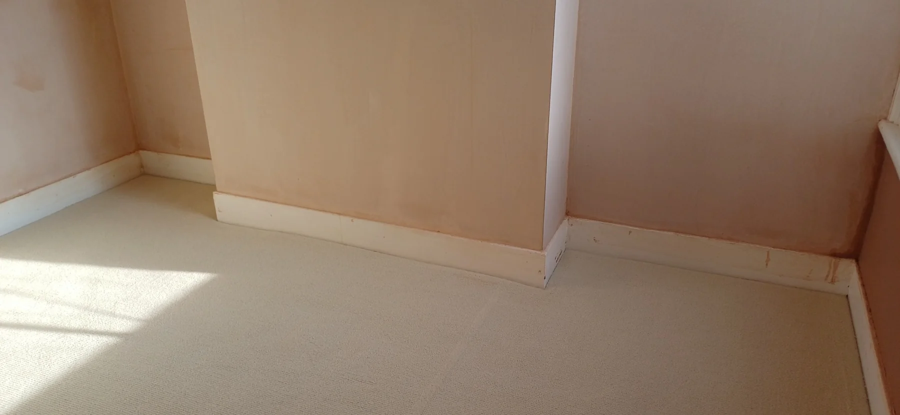 Skimmed chimney breast and adjoining alcoves above white skirting boards in Brentford.