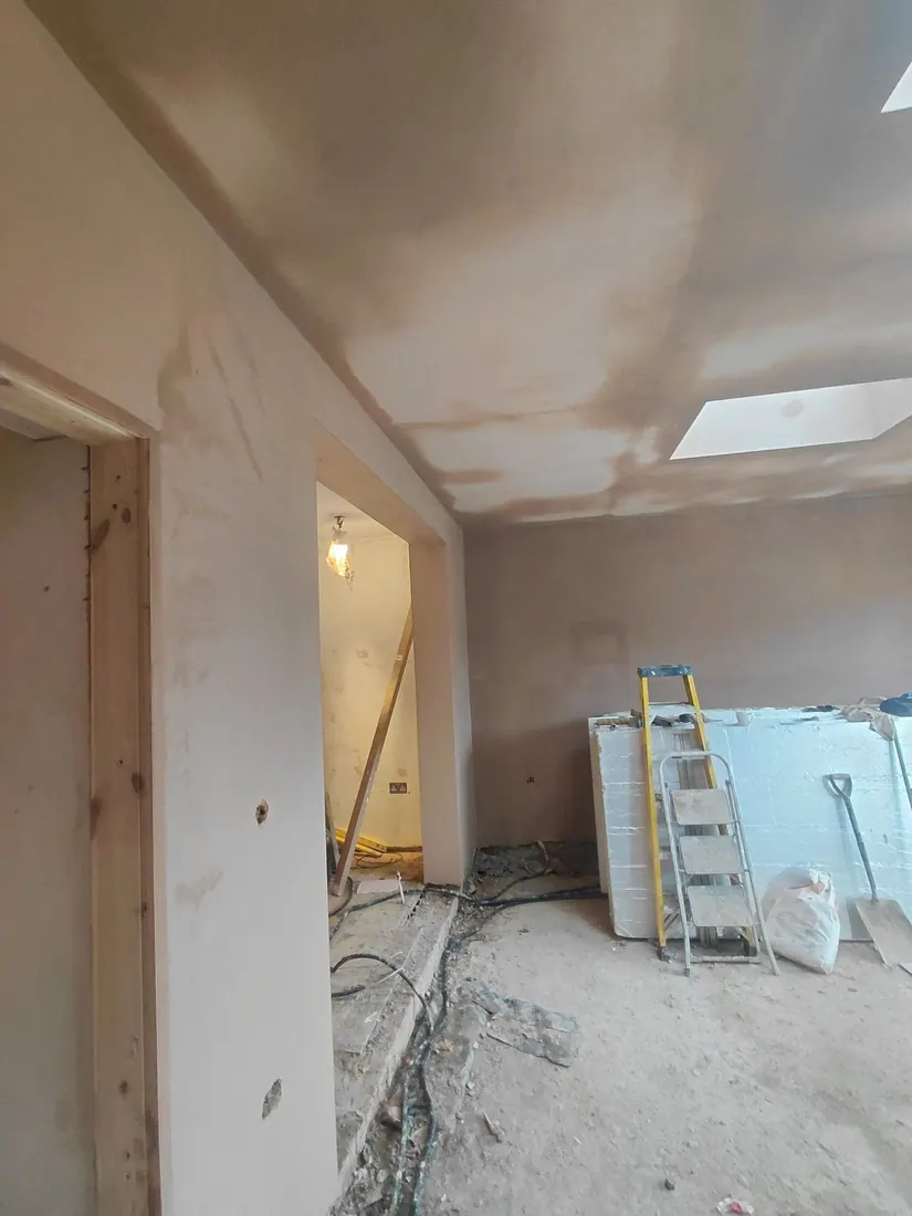 Walls and ceiling being plastered in a home extension