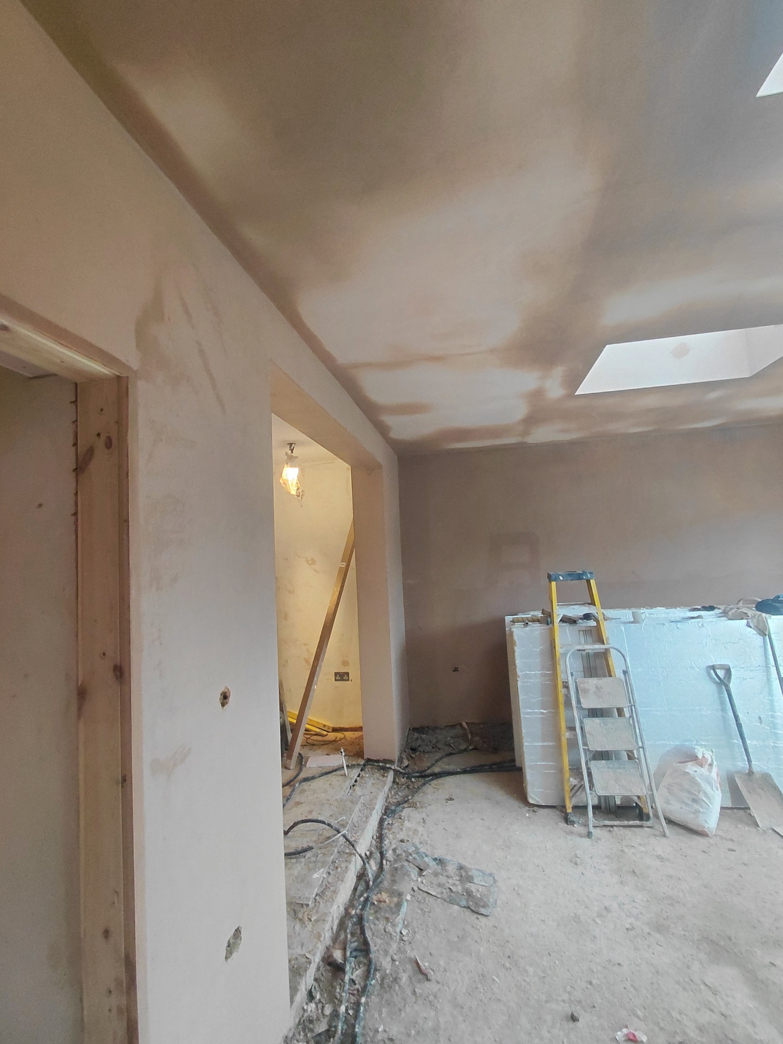 Walls and ceiling being plastered in a home extension