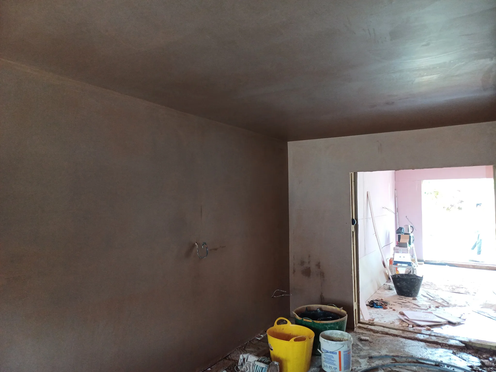 New plaster finish on the walls and ceiling of an interior room