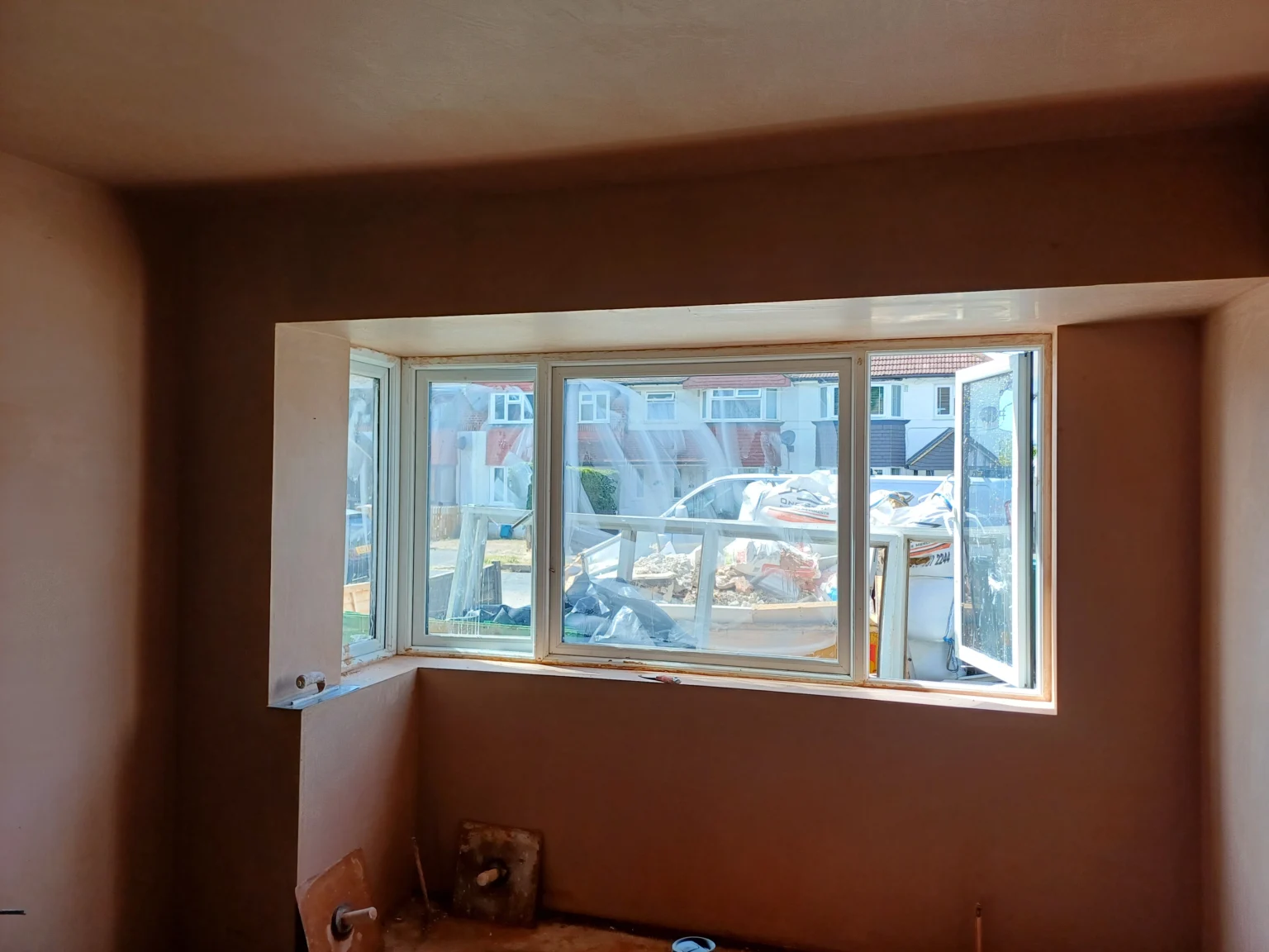 New plaster on the walls of a room with a bay window